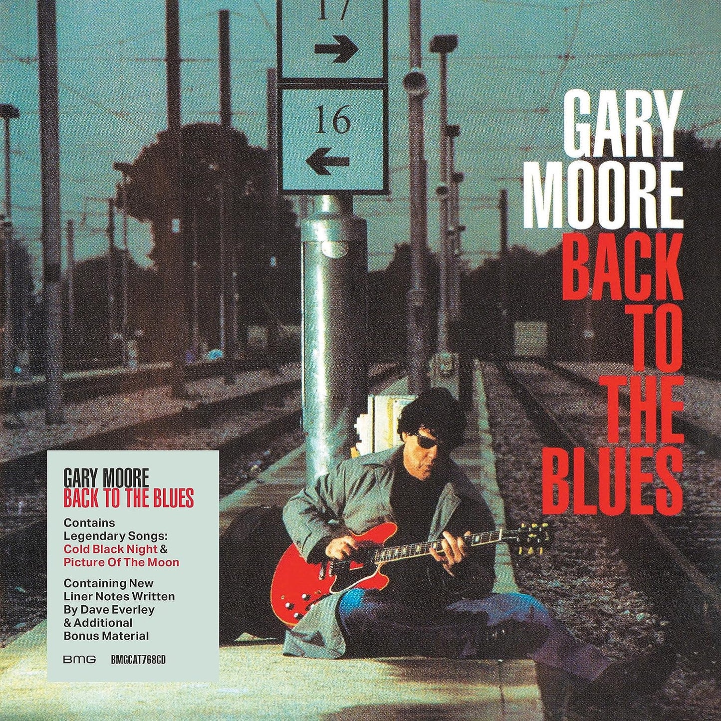 Gary Moore album cover: musician with red guitar at a train station.