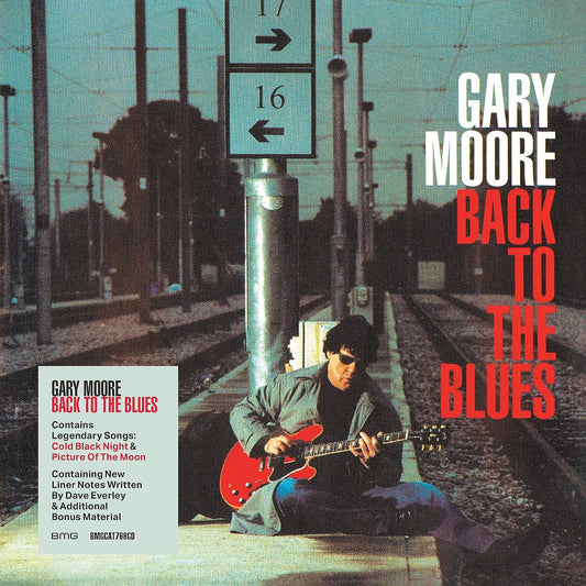 Gary Moore album cover: musician with red guitar at a train station.