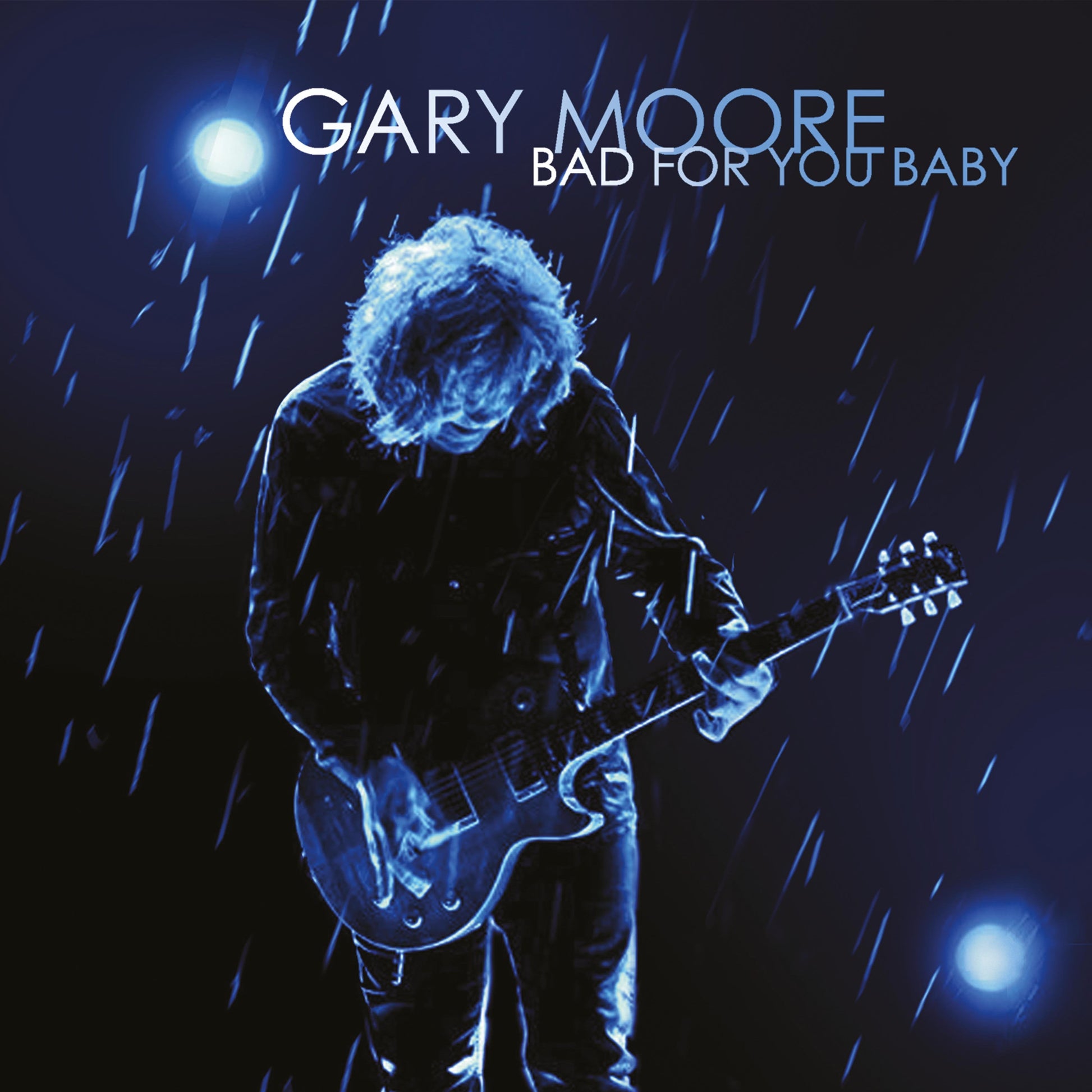 Gary Moore album cover: musician with guitar in blue rain.