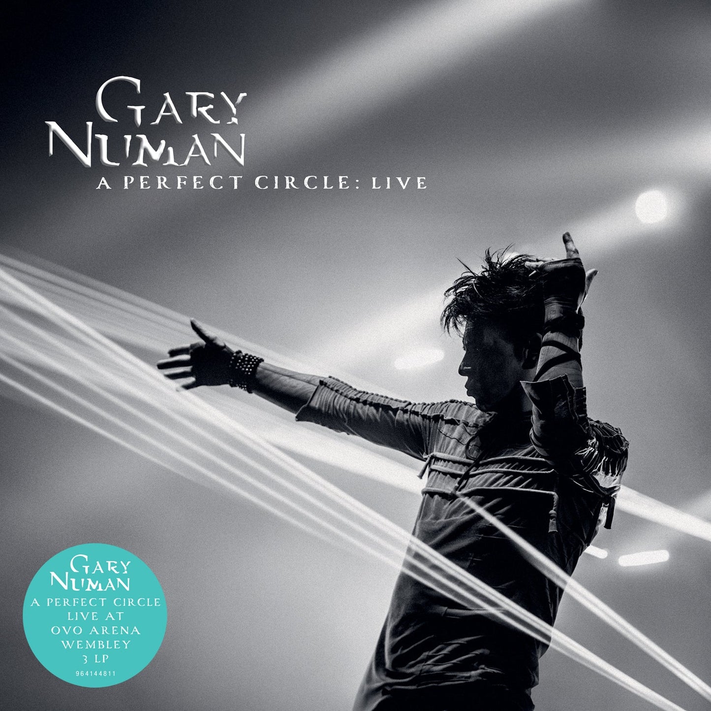 Gary Numan album cover: black and white image of artist with outstretched hands.