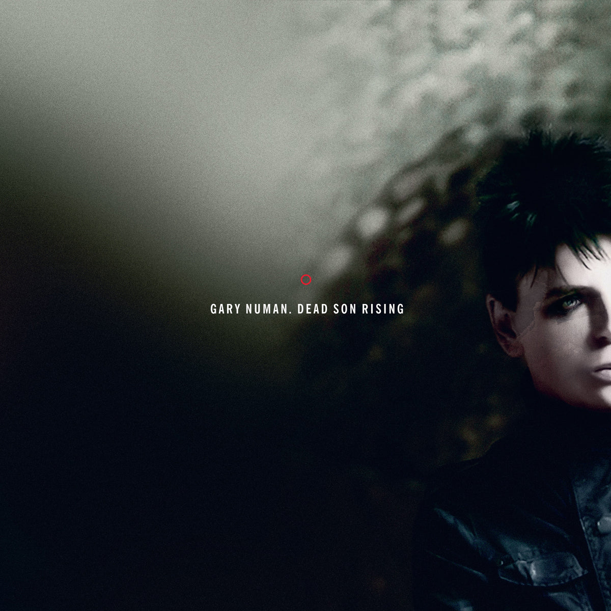 Gary Numan album cover: dark portrait with red dot and text.