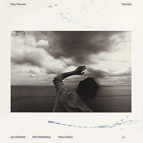 CD cover: a person reaching towards a cloudy sky over water.