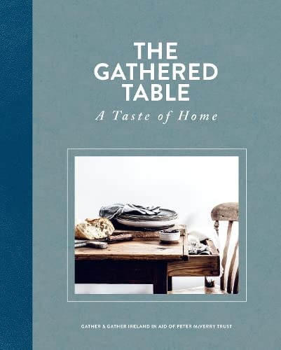 Cookbook cover with rustic bread, a bowl, and wooden table setting.