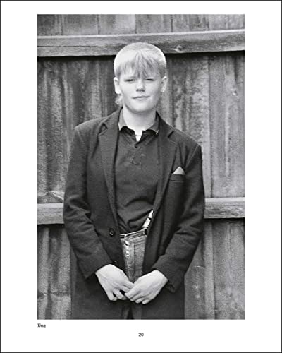 Black and white portrait of a young person in a blazer and polo shirt.