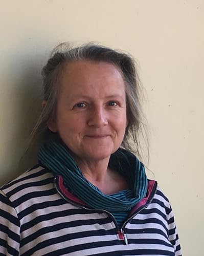 Headshot of a woman with grey hair, wearing a striped shirt and scarf.