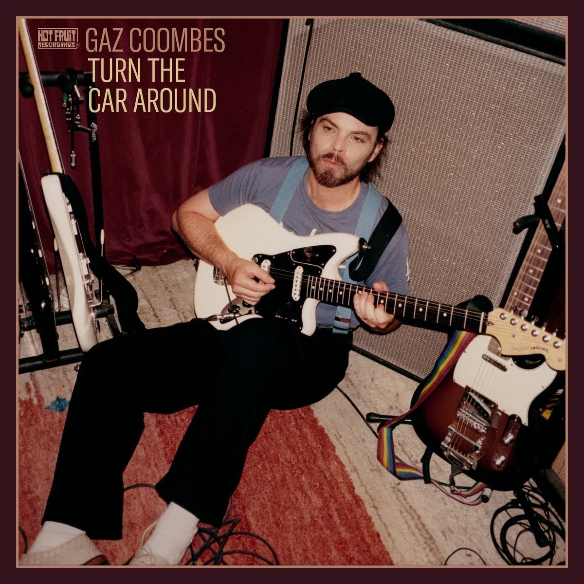 Gaz Coombes album cover featuring a seated man playing a white electric guitar.
