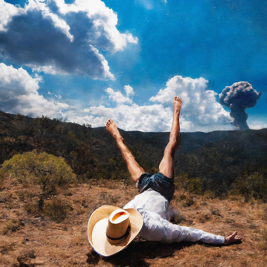 Person lying on back under a cloudy sky with a distant explosion.
