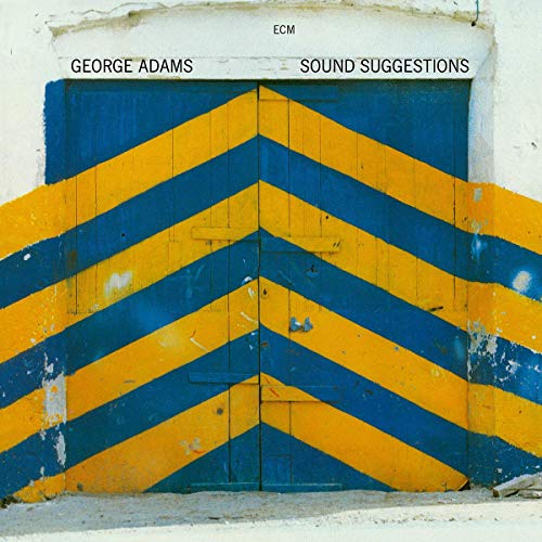 "Album cover featuring a distressed, blue and yellow chevron-patterned door on a white wall."