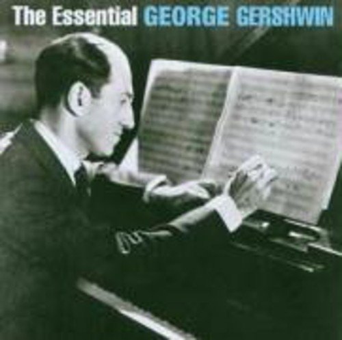 Black and white photo of George Gershwin at a piano with sheet music.