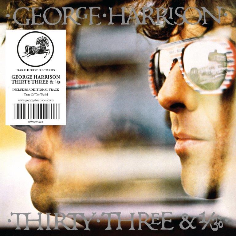 George Harrison wearing sunglasses with a white information sticker on the left side.