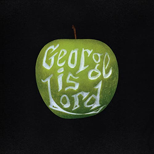 Green apple with white text reading "George Is Lord" carved into it.
