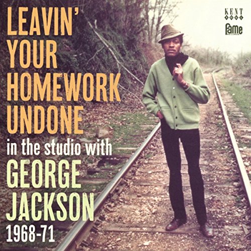 "Album cover featuring a man standing on train tracks, wearing a hat and green jacket."
