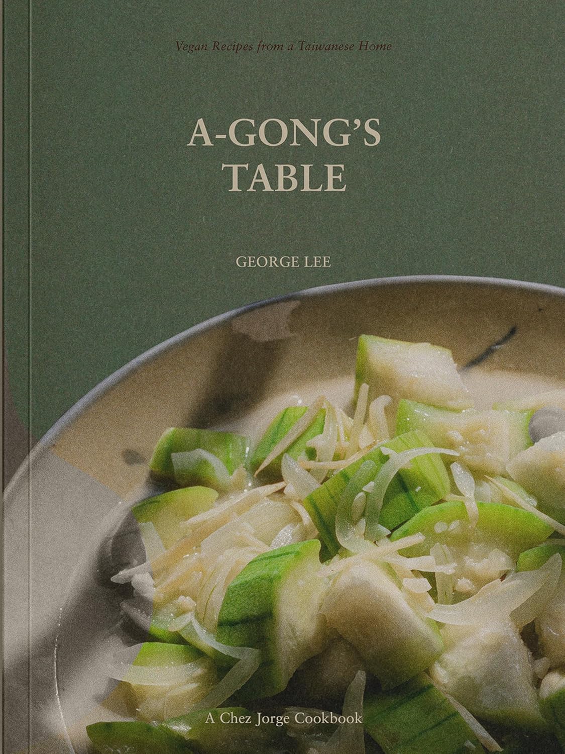 Cookbook cover, “A-Gong’s Table,” featuring a dish of stir-fried vegetables.