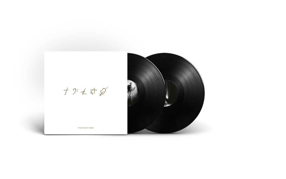 Two black vinyl records with a white album cover featuring text.