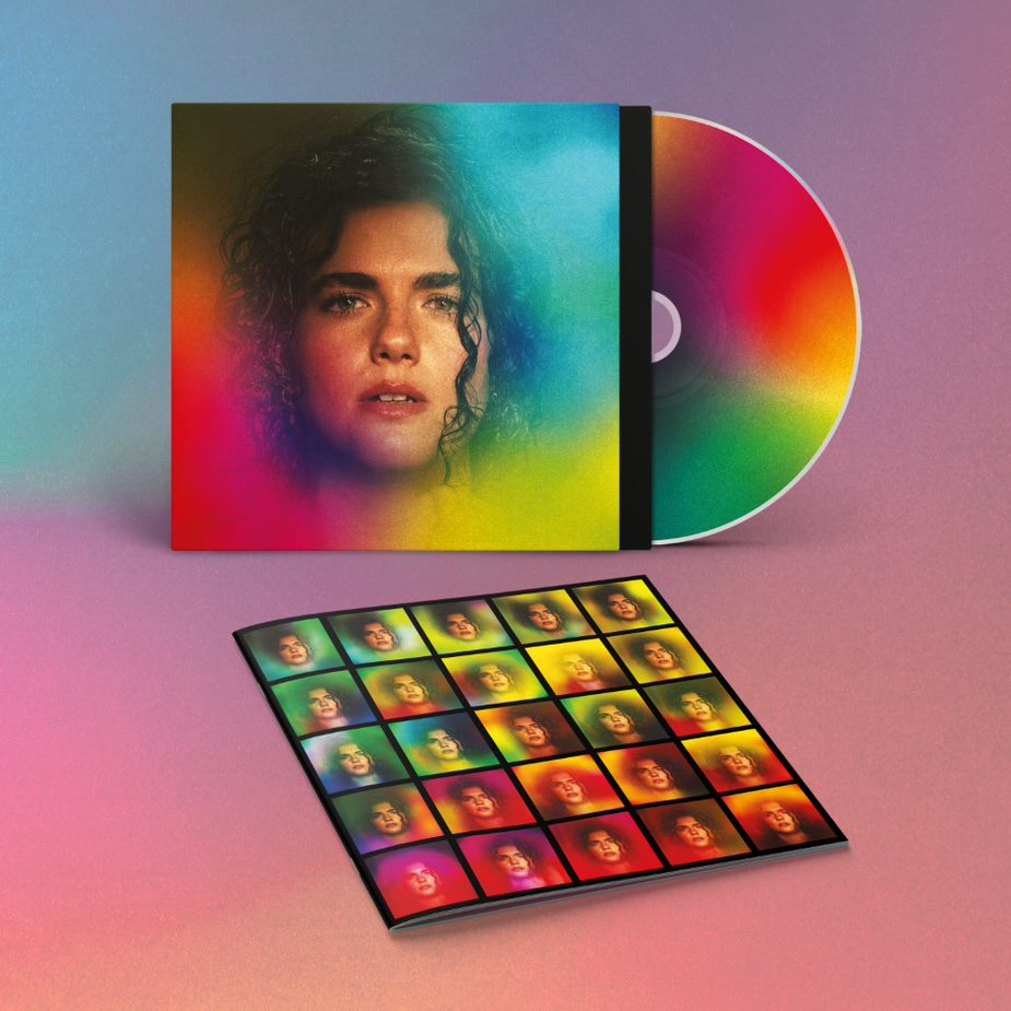 "CD case, disc, and booklet with a woman's portrait on rainbow background."