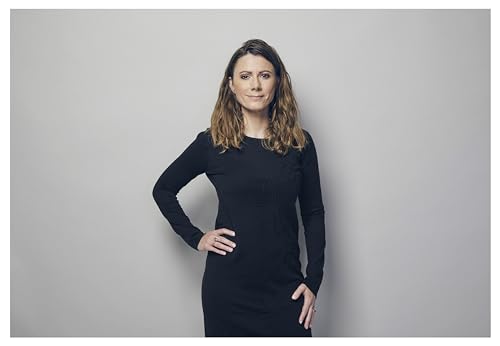 Woman with wavy brown hair wearing a black long-sleeved dress.