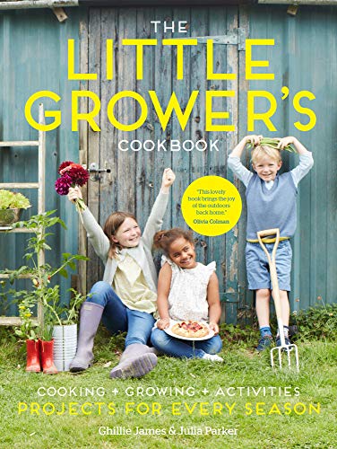 Three children sit in front of a blue wooden shed holding flowers and food.