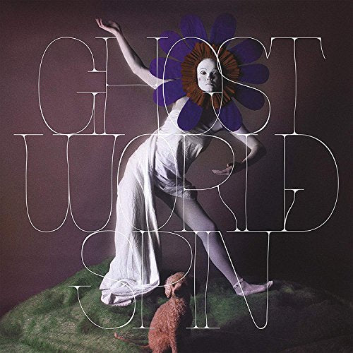 "Album cover with a dancer in white dress and flower headpiece, on green surface."