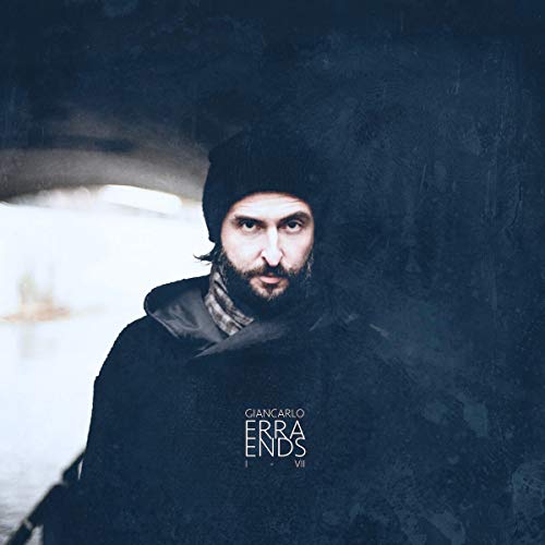 Portrait of Giancarlo Erra in a black beanie and coat, album cover.