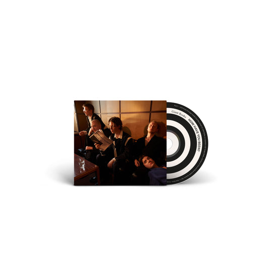 CD cover featuring a group of people in a dimly lit room.
