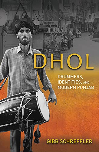 Book cover featuring a man holding a large dhol drum in India.