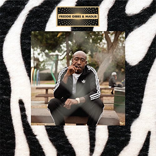Freddie Gibbs album cover with a zebra print border and park scene.