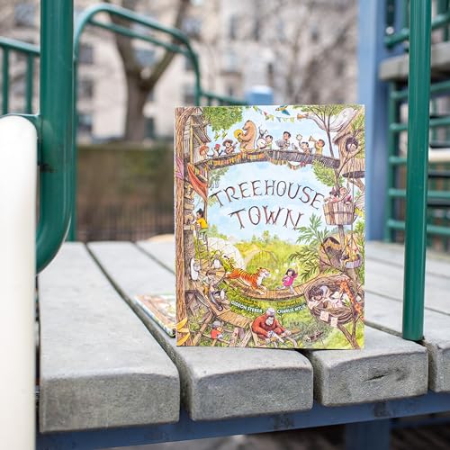 The Treehouse Town children's book cover rests on a wooden playground structure.