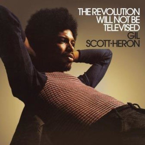 Gil Scott-Heron with an afro, hands behind his head, on a tan background.