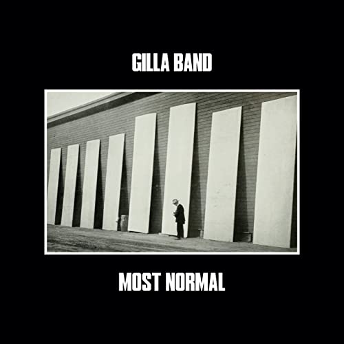 Gilla Band album cover: a man stands before large, pale wall panels.