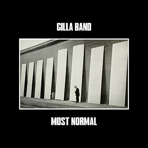 Gilla Band album cover: a man stands before large, blank wall panels.