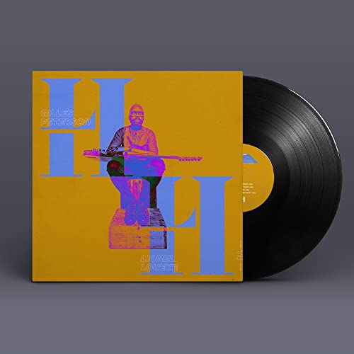 Vinyl record with yellow cover featuring a guitarist and bold blue letters.