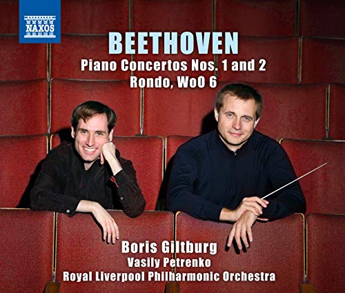 "CD cover with two men in black, one holding a conductor's baton, on red seats."