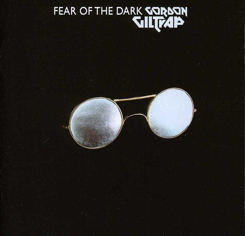 A black album cover with white text and an image of round sunglasses.