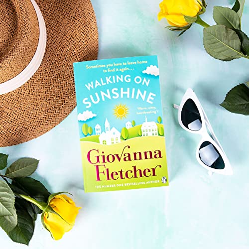 Book "Walking on Sunshine" with a straw hat, roses, and sunglasses.