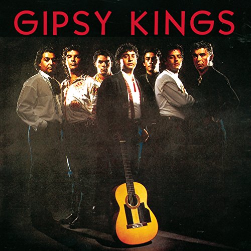 Six men standing behind an acoustic guitar with red text reading Gipsy Kings.