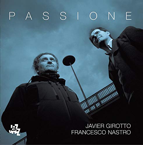 CD cover featuring two men looking upwards against a blue sky.