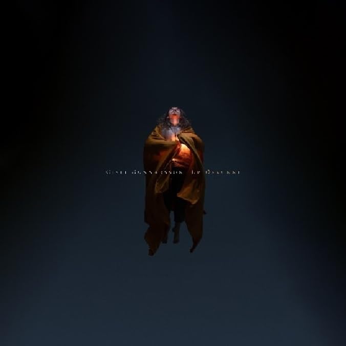 CD cover: a cloaked figure holding a light source, dark background.