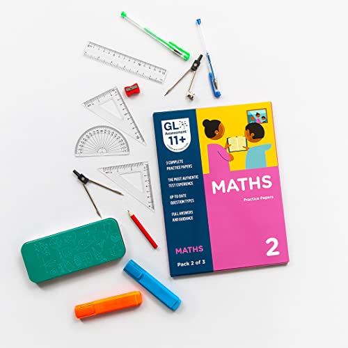 Maths practice papers and tools arranged on a white surface.