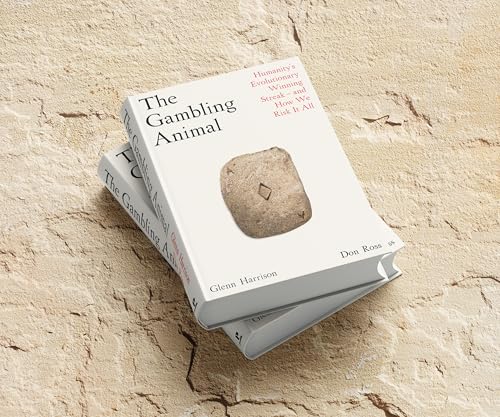 Two white books titled “The Gambling Animal” stacked on a textured surface.