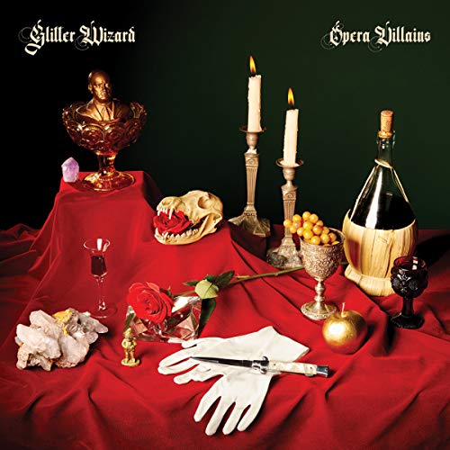 "Album cover featuring a table with red cloth, skull, candles, wine, and various ornaments."
