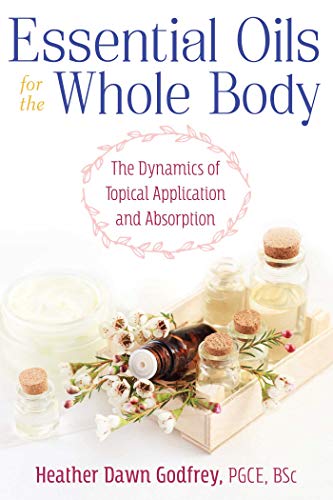 Book cover with essential oil bottles, flowers, and cream jars.