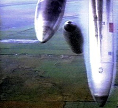 Blurred image of bombs falling from an aircraft, CD cover art.