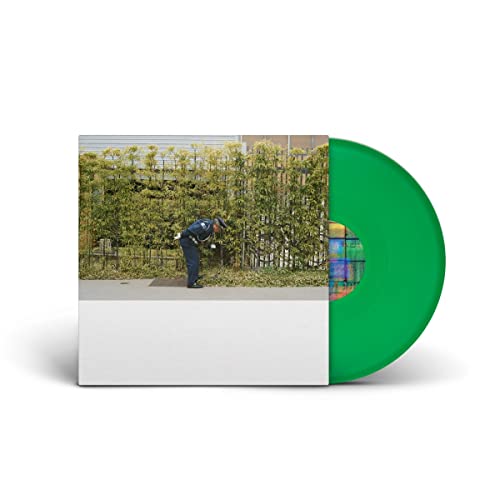 Vinyl record with light green color and album art of a person outdoors.