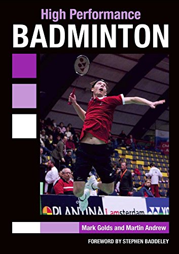 Badminton player mid-air hitting shuttlecock during a match in an arena.