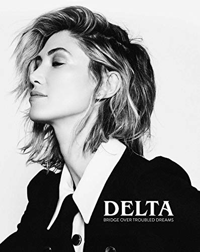 Black and white portrait of Delta Goodrem, book cover titled "Bridge Over Troubled Dreams".