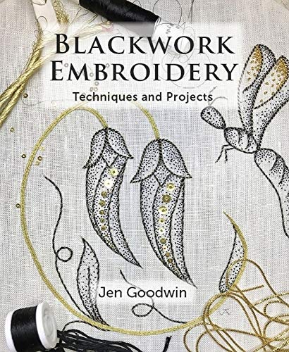 Book cover featuring blackwork embroidery of floral shapes and a dragonfly on white fabric.