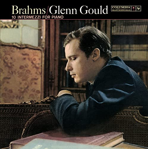 Glenn Gould portrait on a classical music CD cover, bookshelves visible.
