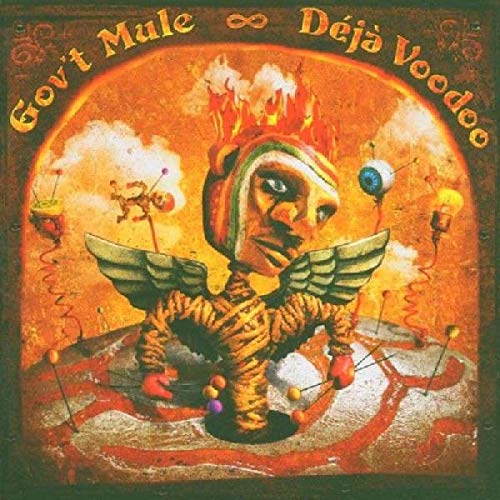 “Déjà Voodoo” CD cover: surreal art with a winged, masked figure.