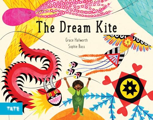 Boy holding kite strings with colorful, whimsical kites in the sky.