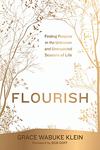 Book cover with gold foil lettering and a delicate tree branch design.